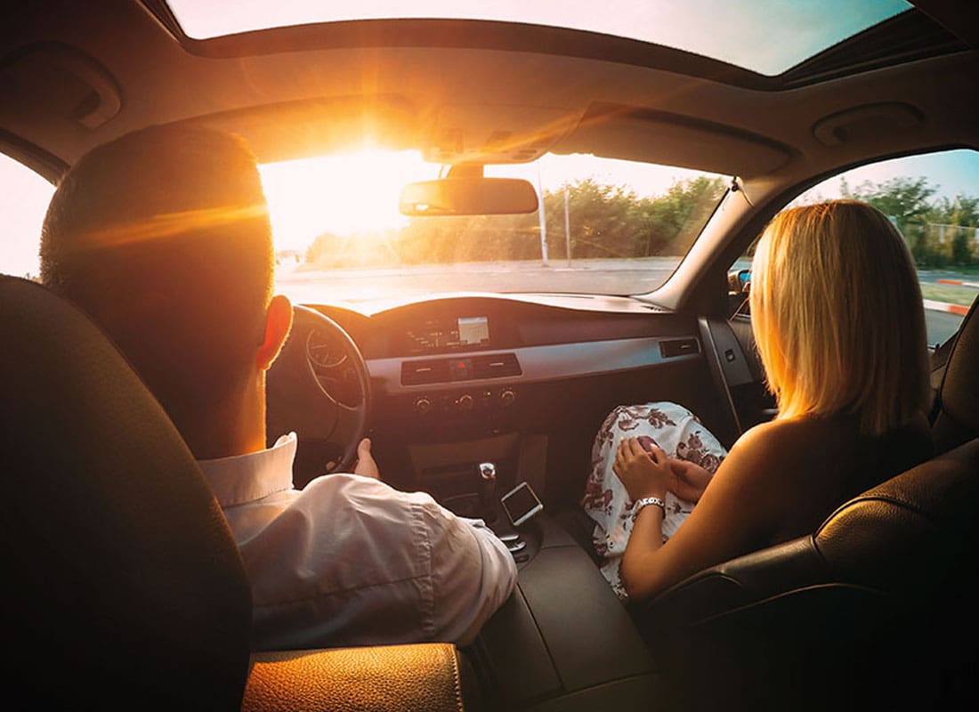 YouTurn-Program-Husband-and-Wife-Driving-in-their-New-Car-with-the-Sun-Coming-Through-the-Window